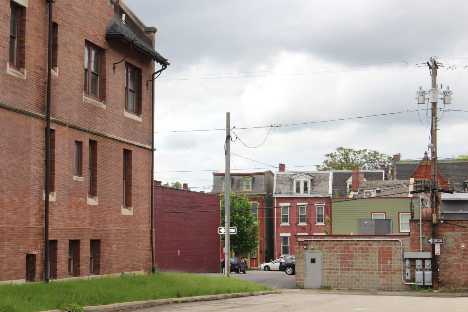 A street with brick buildings and a power pole.